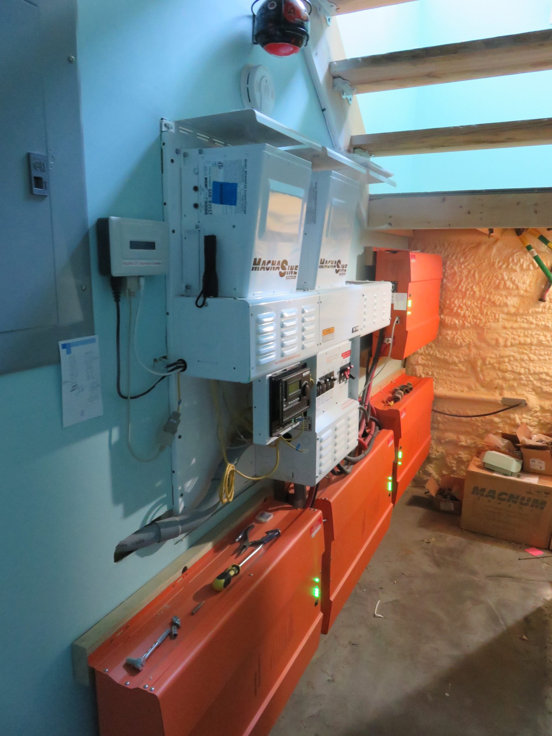 Breaker boxes and battery inverter wall by Keowee Home Solar